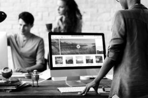 A group of entrepreneurs and business owners discussing the perfect domain name for their business at an office desk.