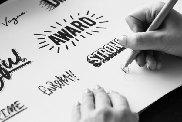 woman drawing word art and logo designs to create a strong brand for a business client
