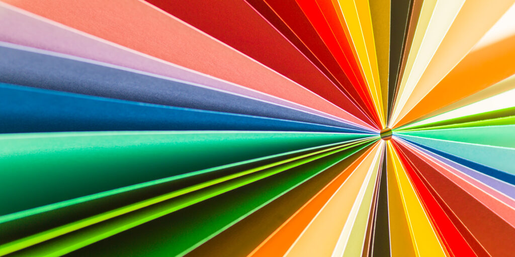Rainbow colored paper spread out like a sunburst.