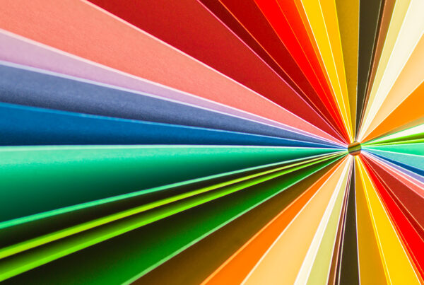 Rainbow colored paper spread out like a sunburst.
